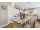 Beautiful kitchen with a large island, granite countertops, and modern light fixtures at 7743 S Quantock Way, Aurora, CO 80016
