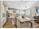 Bright and open kitchen with granite countertops and a large island that flows seamlessly into the adjacent living space at 7743 S Quantock Way, Aurora, CO 80016