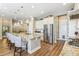 Open-concept kitchen features a large island with seating and overlooks the living area, perfect for modern living at 7743 S Quantock Way, Aurora, CO 80016