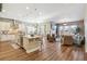 Open-concept living room and kitchen with hardwood floors and abundant natural light at 7743 S Quantock Way, Aurora, CO 80016