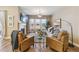 Cozy living room featuring a fireplace, comfortable seating, and ample natural light at 7743 S Quantock Way, Aurora, CO 80016