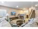Inviting living room with cozy seating, a wet bar, and staircase, perfect for entertaining and relaxation at 7743 S Quantock Way, Aurora, CO 80016
