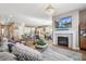 Open-concept living space connects the living room to the kitchen, with a fireplace and tv visible at 7743 S Quantock Way, Aurora, CO 80016