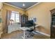 A home office with built-in shelves, a desk, and ample natural light at 7743 S Quantock Way, Aurora, CO 80016