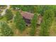 Aerial view of a rustic home with a brown roof, surrounded by lush greenery and mature trees at 9745 Hilldale Dr, Morrison, CO 80465