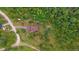 Overhead view of a home with a brown roof and a lush green landscape surrounding a quaint property at 9745 Hilldale Dr, Morrison, CO 80465