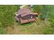 A high angle of a house featuring a spacious deck and a neatly maintained yard, surrounded by mature trees at 9745 Hilldale Dr, Morrison, CO 80465