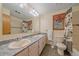 Bathroom with a large mirror, double sinks, and wood trim at 9745 Hilldale Dr, Morrison, CO 80465