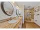 Elegant bathroom with double sinks, granite countertops, and a glass-enclosed shower at 9745 Hilldale Dr, Morrison, CO 80465