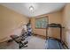 The bedroom features workout equipment and a window providing natural light at 9745 Hilldale Dr, Morrison, CO 80465