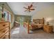Spacious bedroom with a rustic wooden bed frame and access to a private balcony at 9745 Hilldale Dr, Morrison, CO 80465
