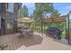 Inviting outdoor deck with a dining set, grill, and a cozy atmosphere at 9745 Hilldale Dr, Morrison, CO 80465