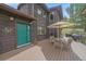 Inviting outdoor deck with a dining set, grill, and a welcoming entrance at 9745 Hilldale Dr, Morrison, CO 80465