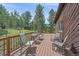 A wooden deck offers outdoor seating with views of the surrounding trees and landscape at 9745 Hilldale Dr, Morrison, CO 80465