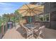 Inviting outdoor deck with a dining set, grill, and a cozy atmosphere at 9745 Hilldale Dr, Morrison, CO 80465