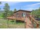 View of the home's exterior featuring a wooden deck, hot tub and walkway at 9745 Hilldale Dr, Morrison, CO 80465