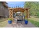 A hot tub is housed inside a gazebo, with potted flowers on the surrounding deck at 9745 Hilldale Dr, Morrison, CO 80465