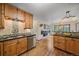 Open kitchen features natural wood cabinets, black granite countertops, and a view to the dining area at 9745 Hilldale Dr, Morrison, CO 80465