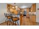 Kitchen and bar area features wood cabinets, stainless steel appliances, and hardwood floors at 9745 Hilldale Dr, Morrison, CO 80465