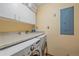 Functional laundry area with ample countertop space and modern washer and dryer units at 9745 Hilldale Dr, Morrison, CO 80465