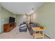 Cozy carpeted living room with comfortable sectional seating and modern lighting at 9745 Hilldale Dr, Morrison, CO 80465