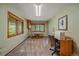 Bright office space with large windows offering wooded views and a functional workspace at 9745 Hilldale Dr, Morrison, CO 80465