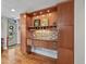 Elegant bar area with custom cabinetry, mosaic tile backsplash, and wine storage at 1717 E 22Nd Ave, Denver, CO 80205