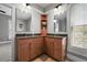 Bright bathroom with double vanity, wood cabinets, and large mirrors at 1717 E 22Nd Ave, Denver, CO 80205