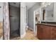 Nicely appointed bathroom with stone pebble shower and a dark vanity at 1717 E 22Nd Ave, Denver, CO 80205