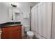 Bright bathroom with a single sink vanity, toilet, and shower/tub combo with white shower curtain at 1717 E 22Nd Ave, Denver, CO 80205