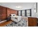 Charming bedroom featuring an exposed brick wall, hardwood floors, and three windows for natural light at 1717 E 22Nd Ave, Denver, CO 80205