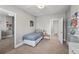 Cozy bedroom with a twin bed, neutral carpet, bright lighting, and two entryways at 1717 E 22Nd Ave, Denver, CO 80205