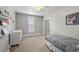 Comfortable bedroom with neutral walls, a twin bed, dresser, and natural light from the window at 1717 E 22Nd Ave, Denver, CO 80205