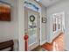 Bright entryway with stained glass transom, hardwood floors, and view to living room at 1717 E 22Nd Ave, Denver, CO 80205