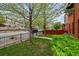 Manicured front lawn with a sidewalk framed by a black metal fence and green bushes at 1717 E 22Nd Ave, Denver, CO 80205