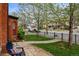 Inviting front yard with a stone pathway and a cozy seating area framed by lush greenery at 1717 E 22Nd Ave, Denver, CO 80205