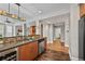 Stylish kitchen with stainless steel appliances, mosaic backsplash, and hardwood floors at 1717 E 22Nd Ave, Denver, CO 80205
