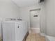 Clean and bright laundry room with a white washer and dryer unit and tiled flooring at 1717 E 22Nd Ave, Denver, CO 80205