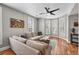 Cozy living room featuring hardwood floors, large sectional sofa, and abundant natural light at 1717 E 22Nd Ave, Denver, CO 80205