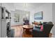 Bright living room with fireplace, hardwood floors, and two comfortable armchairs at 1717 E 22Nd Ave, Denver, CO 80205