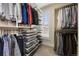 Spacious walk-in closet featuring ample hanging space, shelving, and pull-out drawers for organized storage at 1717 E 22Nd Ave, Denver, CO 80205