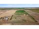 An aerial view of a gorgeous home surrounded by lush fields at 1212 N County Road 125, Bennett, CO 80102