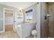 Relaxing bathroom with a soaking tub, separate shower, and a view of the outdoors at 1212 N County Road 125, Bennett, CO 80102