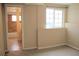 Bright bedroom with window and access to ensuite bathroom featuring tile flooring and shower at 1212 N County Road 125, Bennett, CO 80102