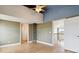 Bedroom features hardwood floors, a ceiling fan, olive-green walls, and ladder to bonus room at 1212 N County Road 125, Bennett, CO 80102
