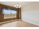 Bright dining room area with wood floors, modern lighting, and a large window offering outdoor views at 1212 N County Road 125, Bennett, CO 80102