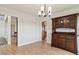 Inviting dining area featuring wood floors, modern lighting, and a vintage china cabinet at 1212 N County Road 125, Bennett, CO 80102