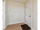 Functional entryway with coat hooks and a decorative rug, providing a welcoming space at 1212 N County Road 125, Bennett, CO 80102