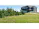 A stunning two-story home with a blue exterior, nestled among lush greenery and open fields at 1212 N County Road 125, Bennett, CO 80102