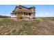Charming two-story home featuring a covered front porch and situated on a spacious lot at 1212 N County Road 125, Bennett, CO 80102